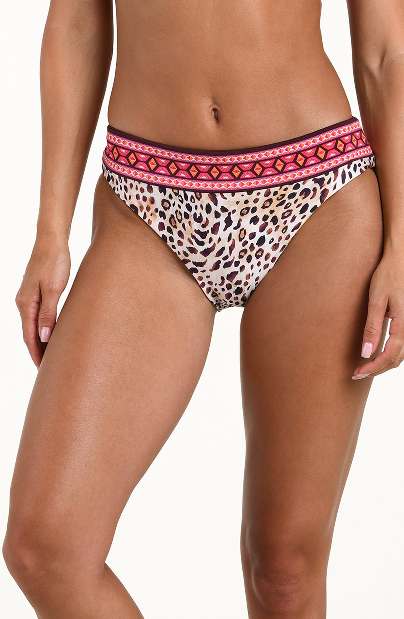 
                  
                    Front image of model wearing a multicolored printed reversible bikini bottom featuring leopard on one side and a tropical print on the other. It has an allover band and moderate rear coverage. 
                  
                
