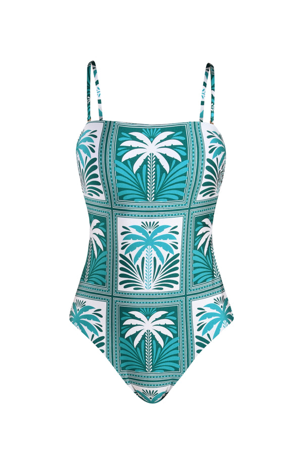 Floating image of a green and white palm tree patterned swimsuit on a white background