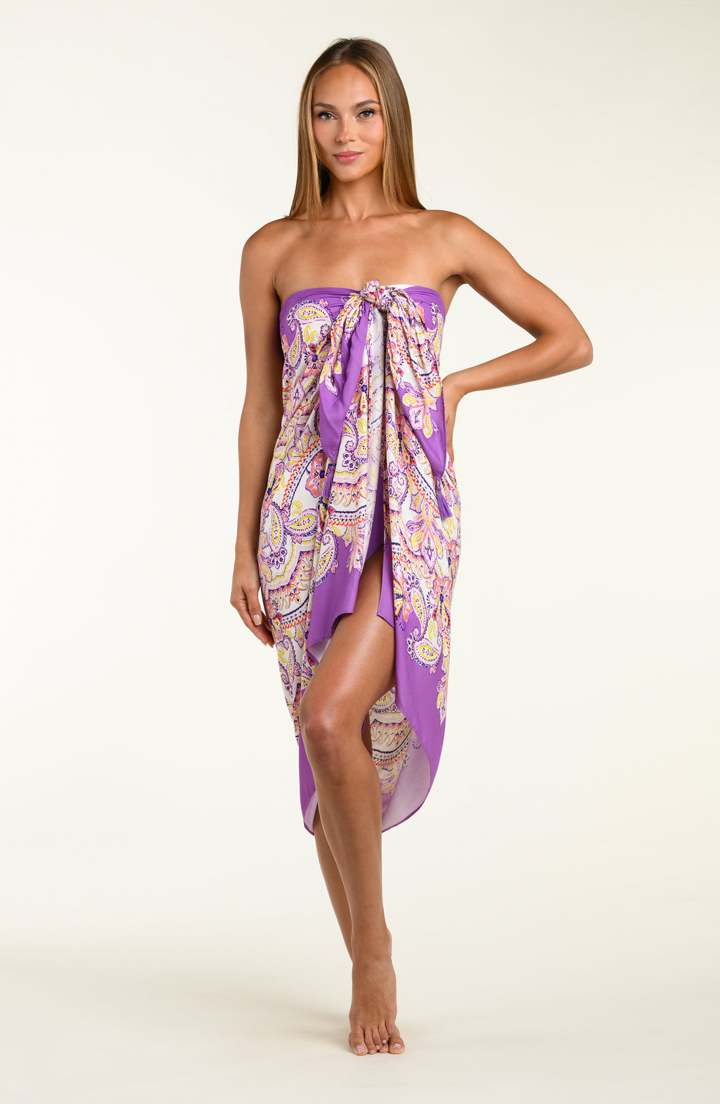 Person wearing a multicolored purple  pareo wrap against a white background