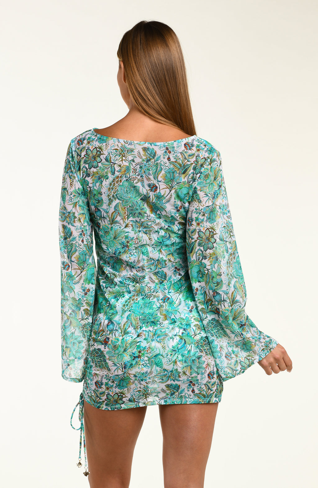 Woman wearing a turquoise floral tunic cover up with bell sleeves on a white background