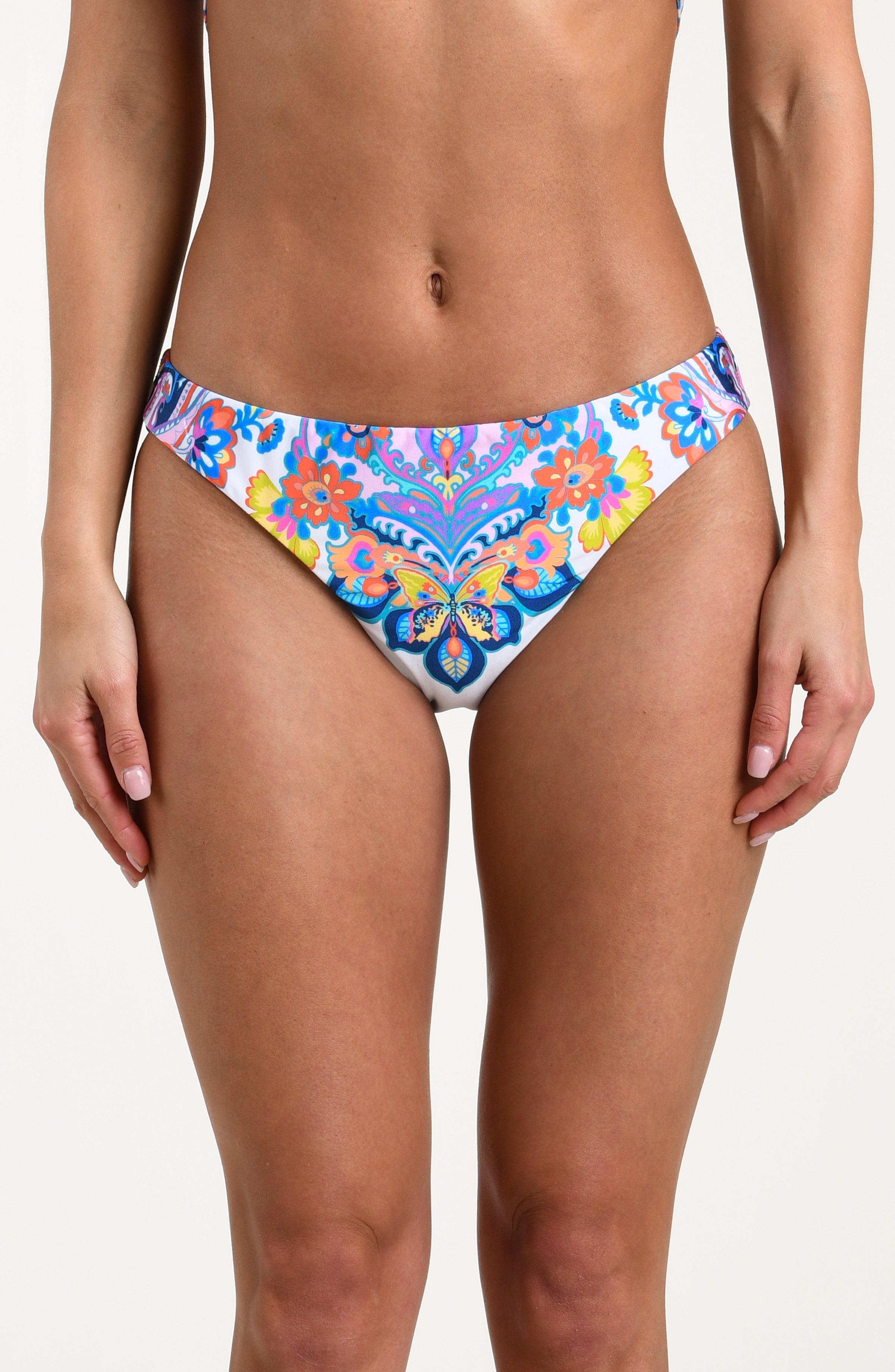 Woman wearing a multicolored bikini bottom against a white background.