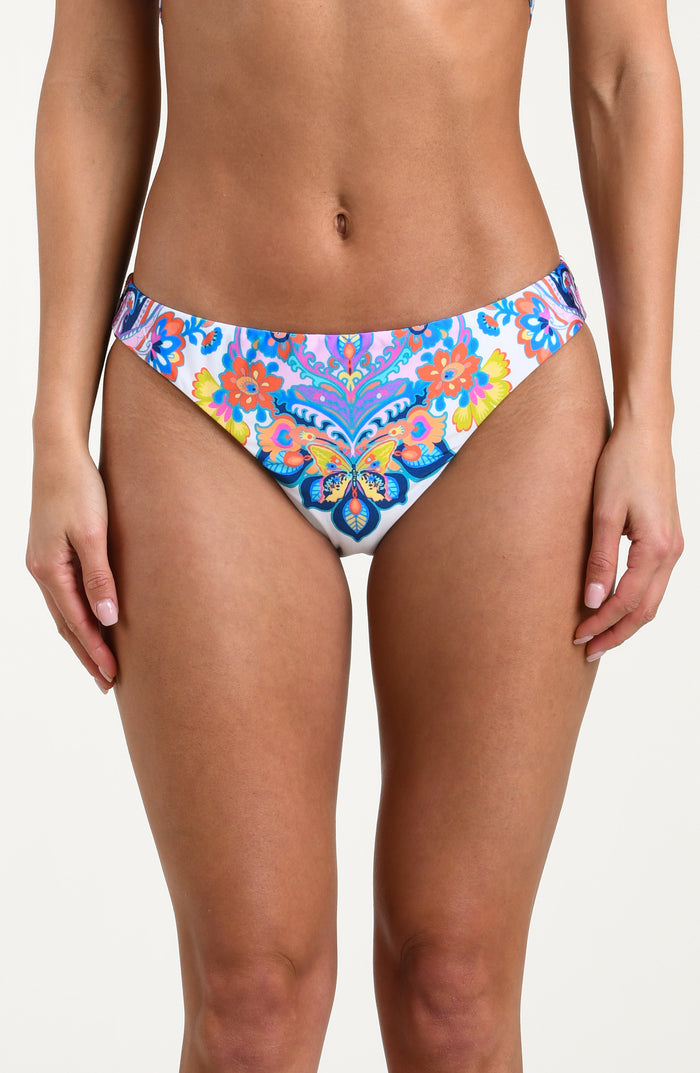 Woman wearing a multicolored bikini bottom against a white background.