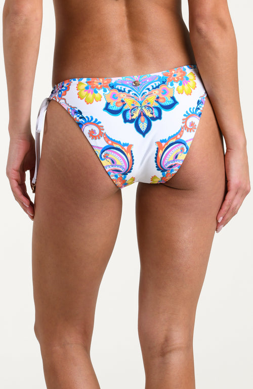 Woman wearing a multicolored bikini bottom against a white background.