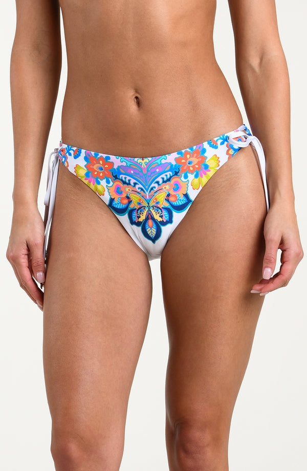 Woman wearing a multicolored bikini bottom against a white background.
