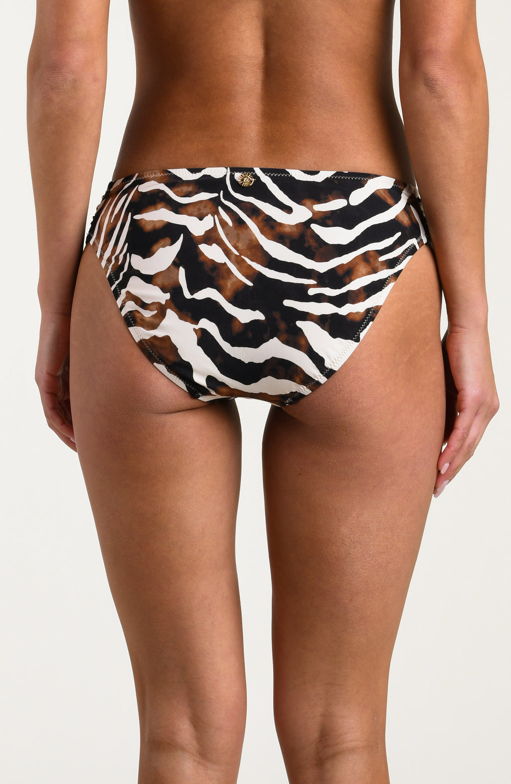 Person wearing a zebra print bikini bottom on a white background