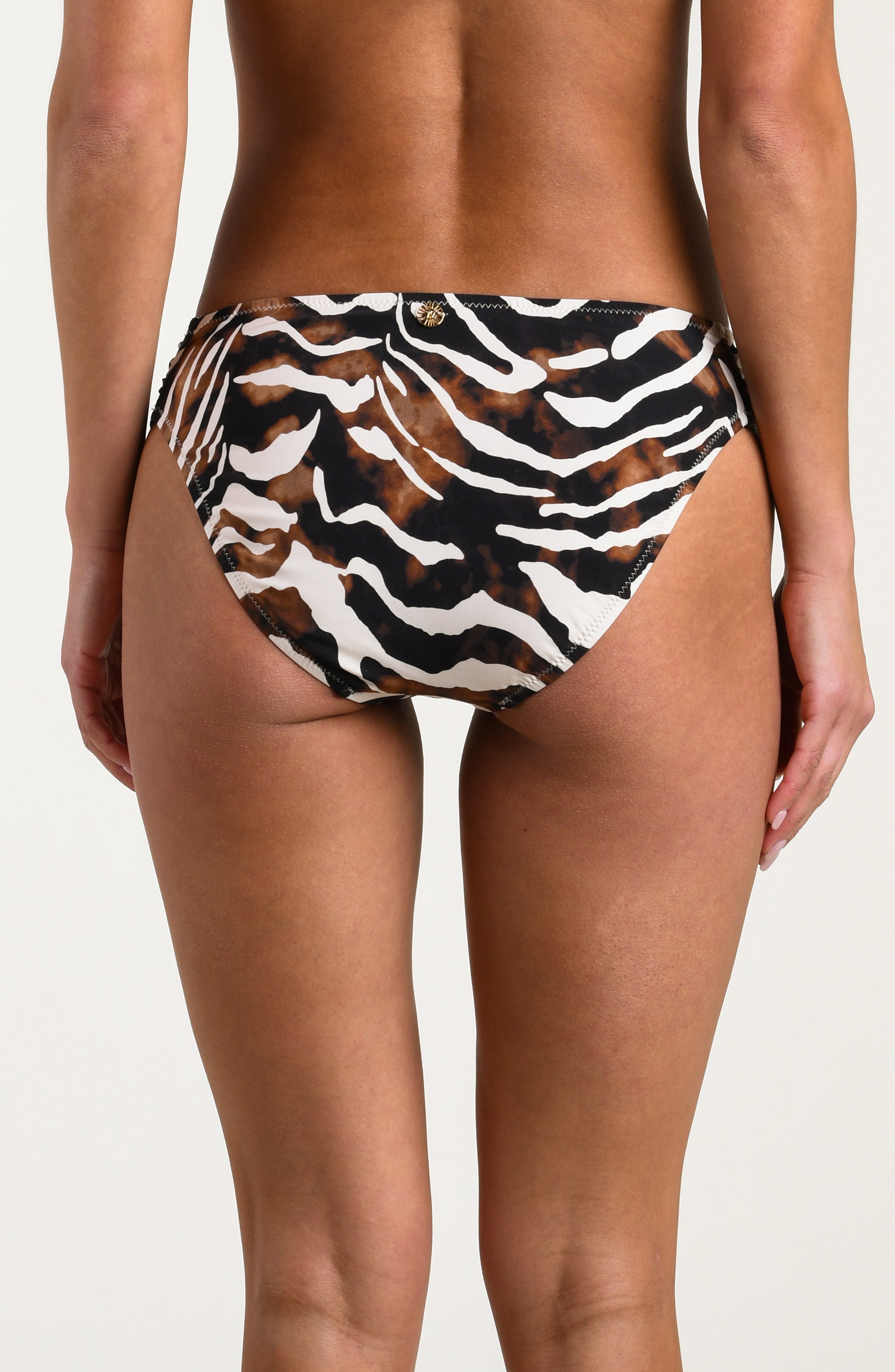 Person wearing a zebra print bikini bottom on a white background