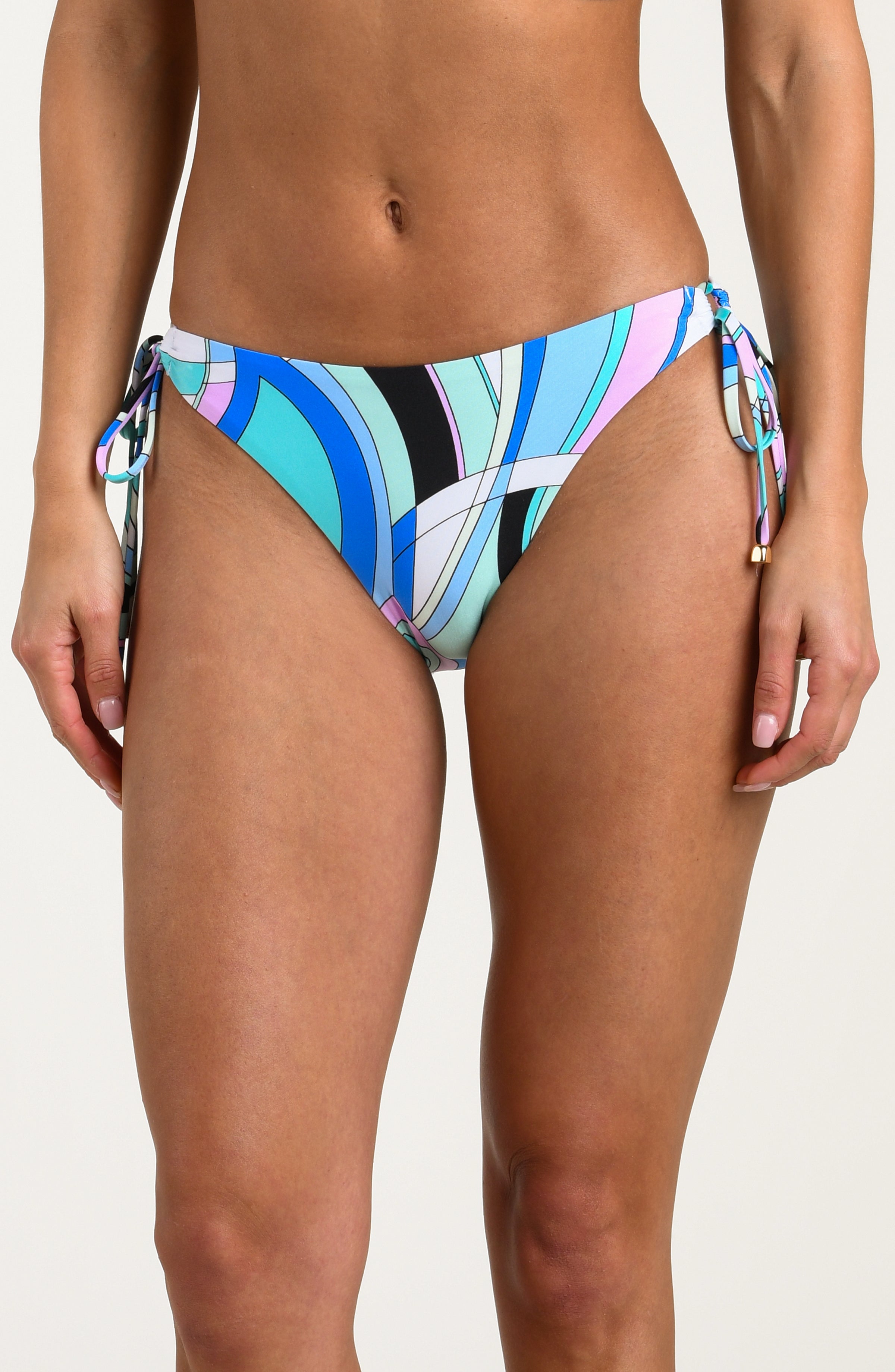 Multicolored bikini bottoms worn by a person against a white background. 