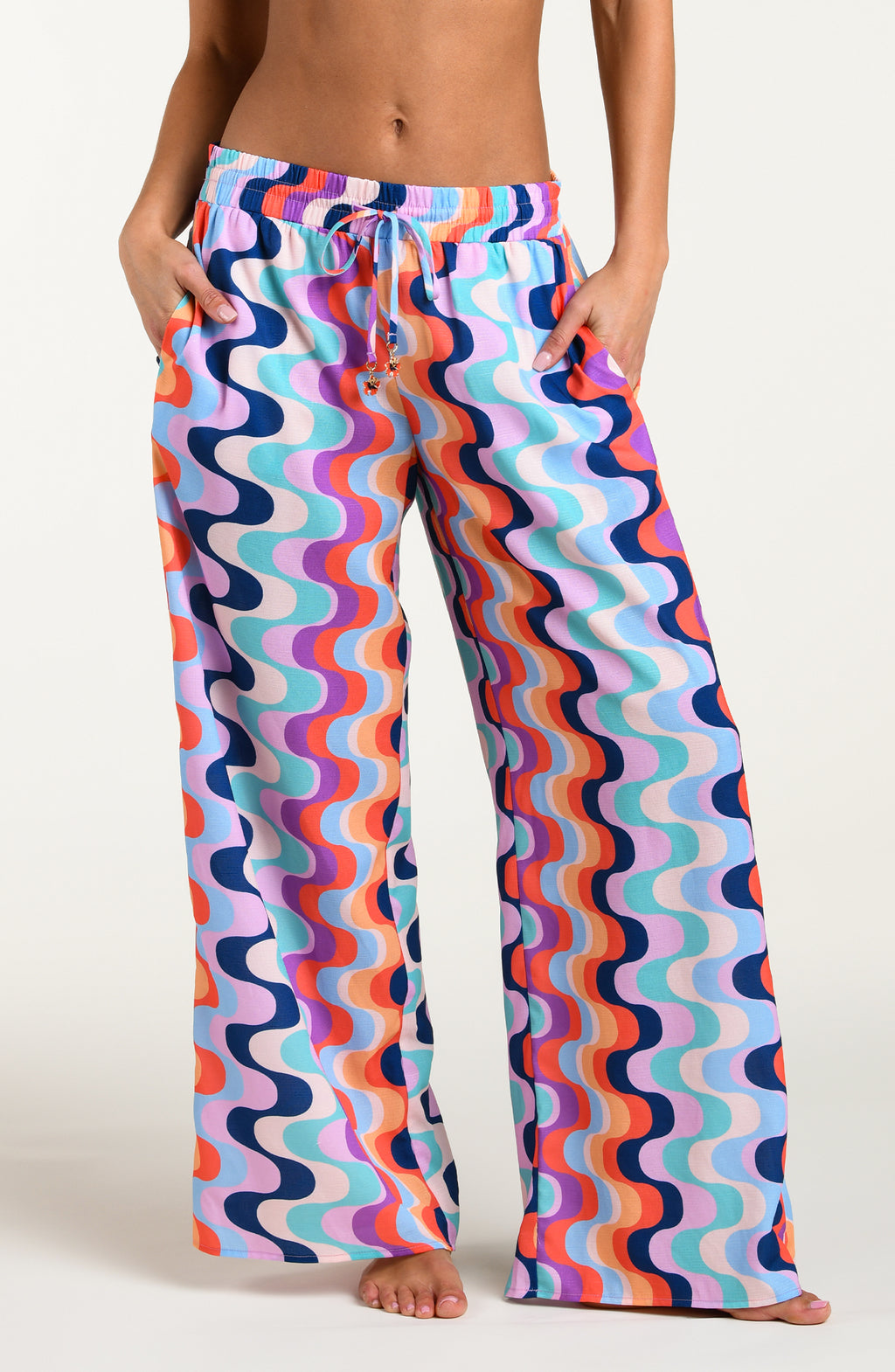 Colorful patterned pants worn by a person on a white background