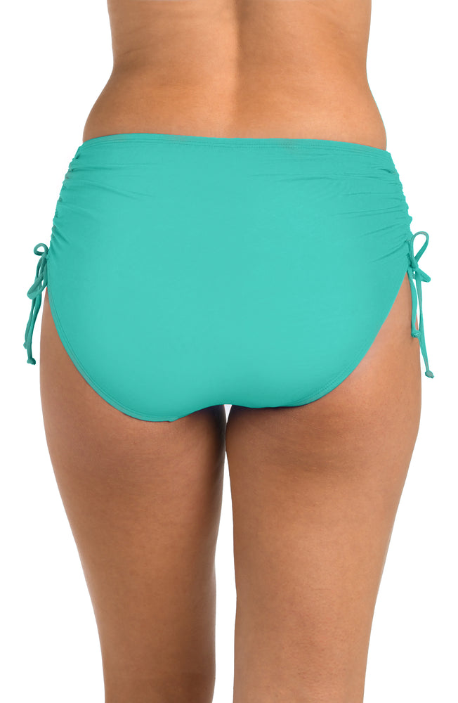 Back image of model wearing the 24th & Ocean Solid Mid Waist Side Tie Hipster Bottom in Aquamarine.