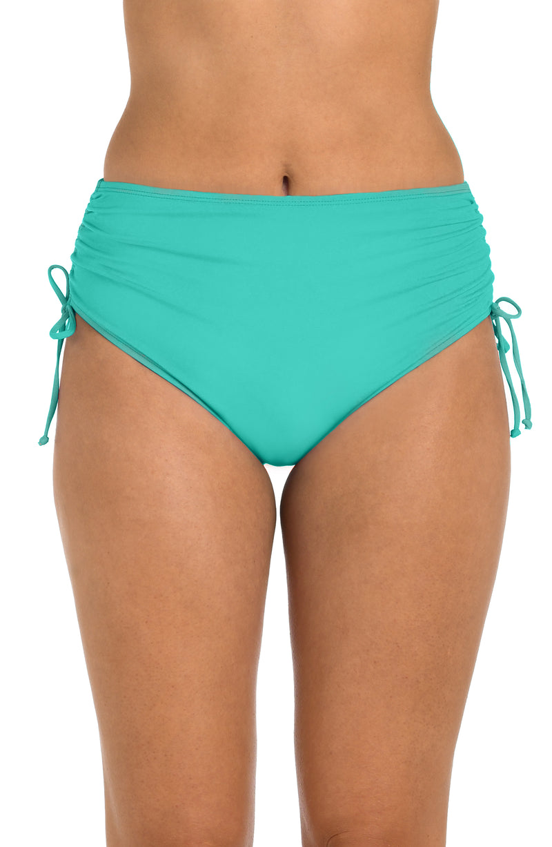 Front image of model wearing the 24th & Ocean Solid Mid Waist Side Tie Hipster Bottom in Aquamarine.