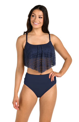 Front image of model wearing the 24th & Ocean Cecily Crochet Handkerchief Flounce Midkini Top in Midnight.