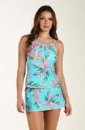 Woman wearing a tropical tankini top and matching bottom on a white background