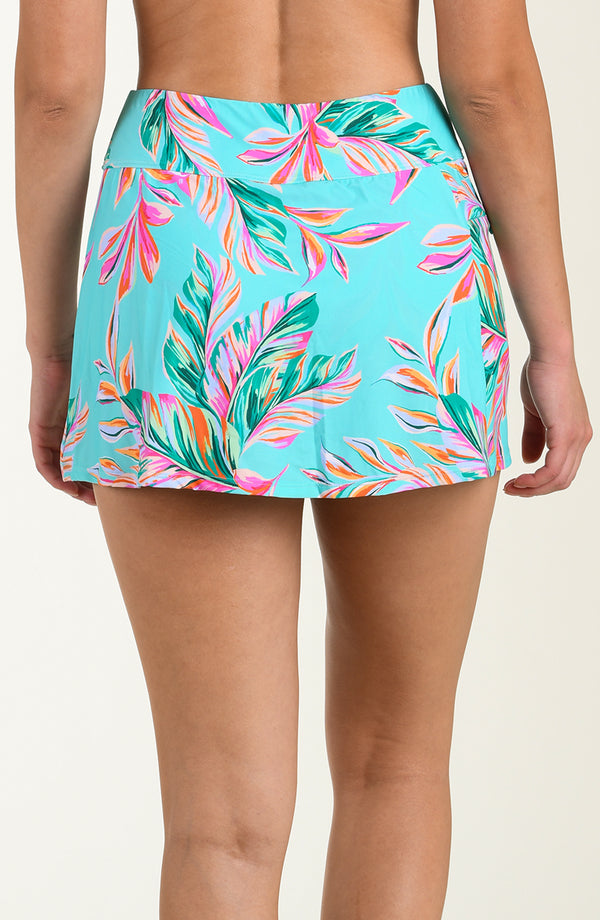 Tropical leaf patterned swim skirt on a plain background