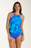 Front image of model wearing a multicolored floral printed tankini top featuring a high neck, adjustable straps, and underwire. This is paired with a periwinkle colored bottom. 