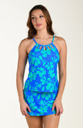 Front image of model wearing a multicolored floral printed tankini top featuring a high neckline, front cutouts, adjustable straps, and underwire. This is paired with a matching swim skort.