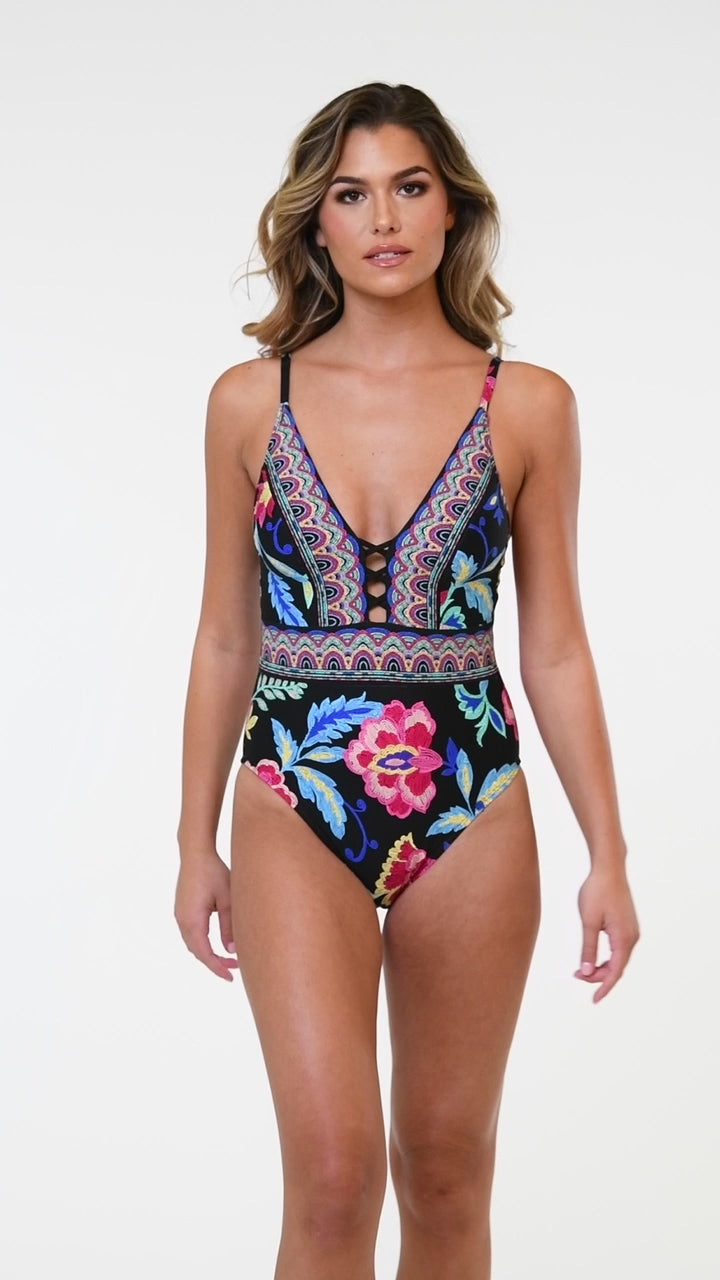 Model is wearing the La Blanca Midnight Magic Plunge One Piece.