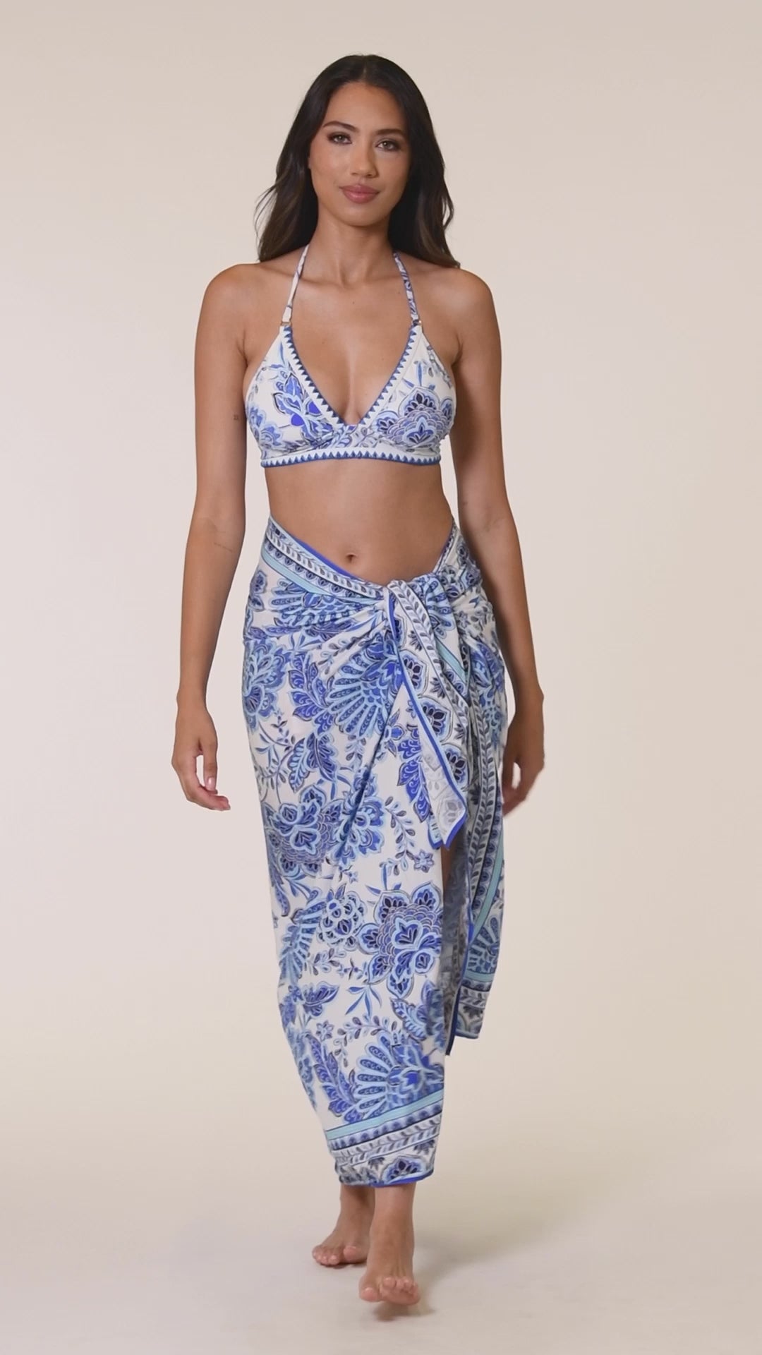 Model is wearing an indigo and white multicolored floral printed Banded Halter Triangle Top