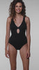Model is wearing a black LB Luxe Plunge One Piece Swimsuit