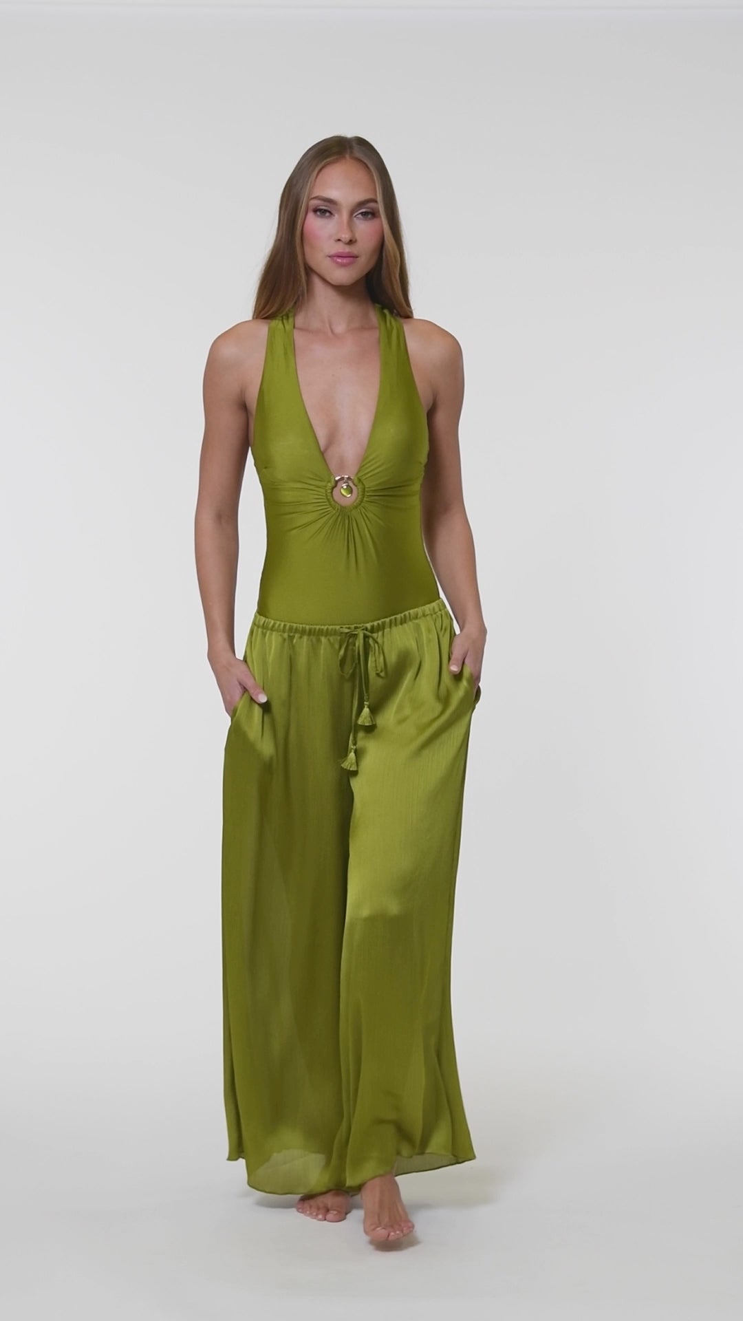 Video of model wearing a solid olive crinkle pant cover up.       