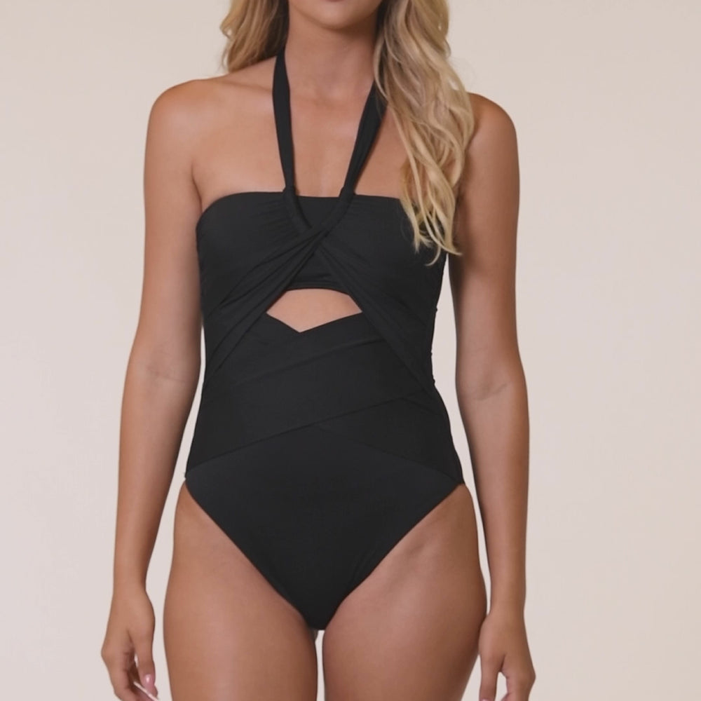 
                  
                    Load and play video in Gallery viewer, Model is wearing a solid black halter one piece swimsuit.
                  
                