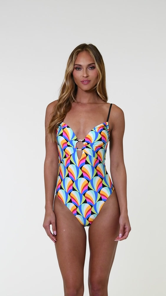 
                  
                    Load and play video in Gallery viewer, Model is wearing a pink, blue, yellow, and orange multicolored over the shoulder triangle bikini top on a geometric patterned black background.
                  
                