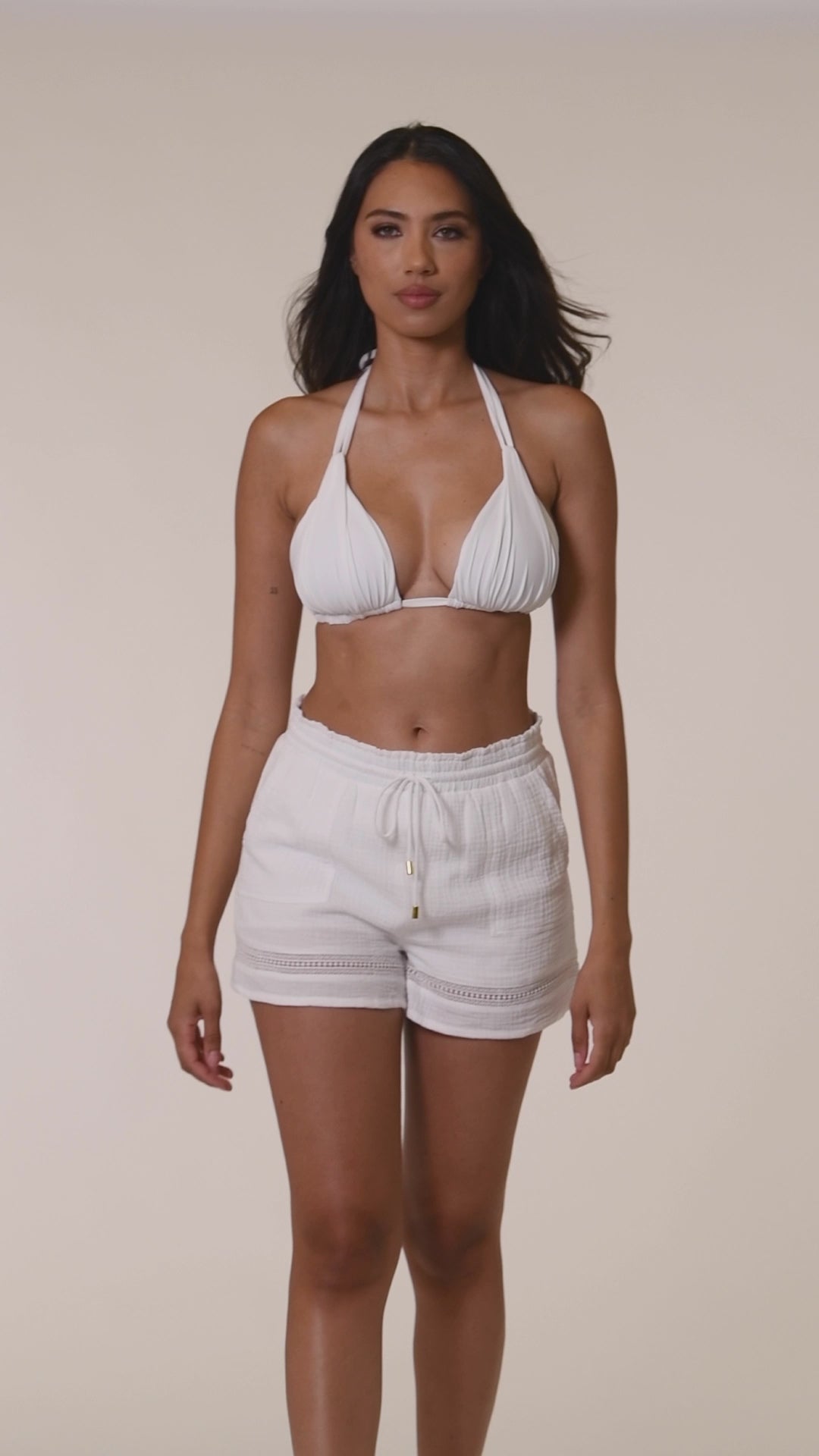 Model is wearing solid white beach shorts from our Seaside Covers collection.