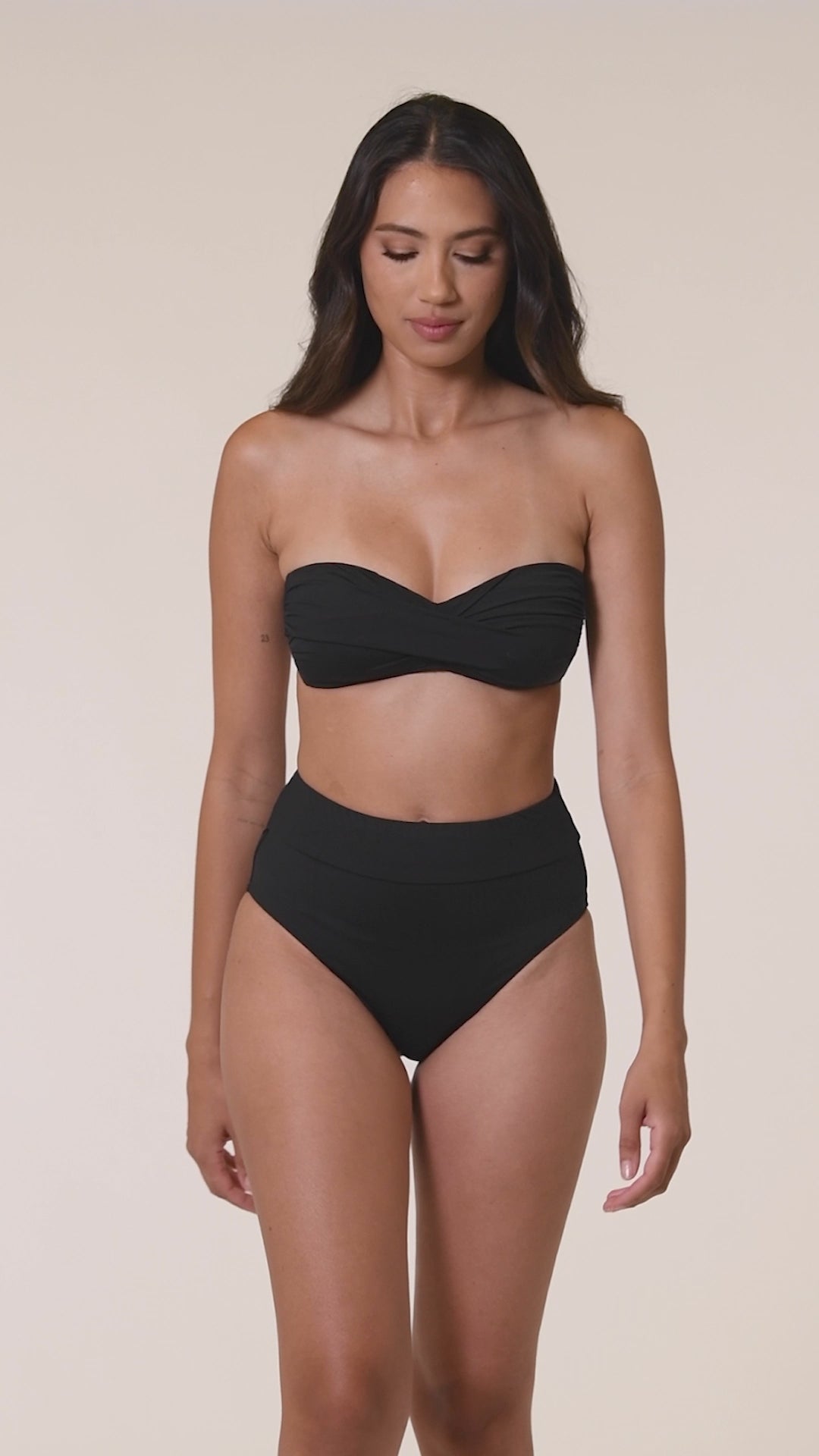 Model is wearing a black bandeau swimsuit top from our Best-Selling Island Goddess collection.