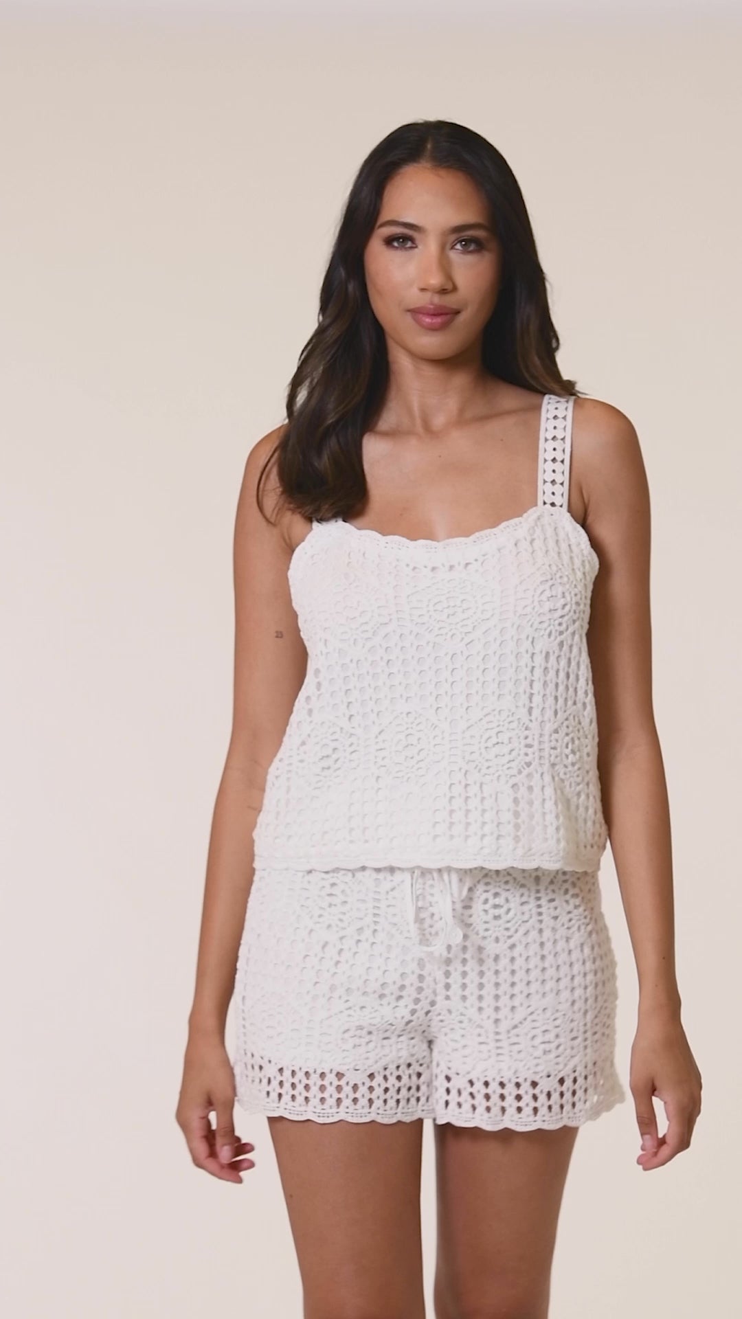 Video of model wearing solid ivory beach shorts and matching tank from our Waverly Covers collection.