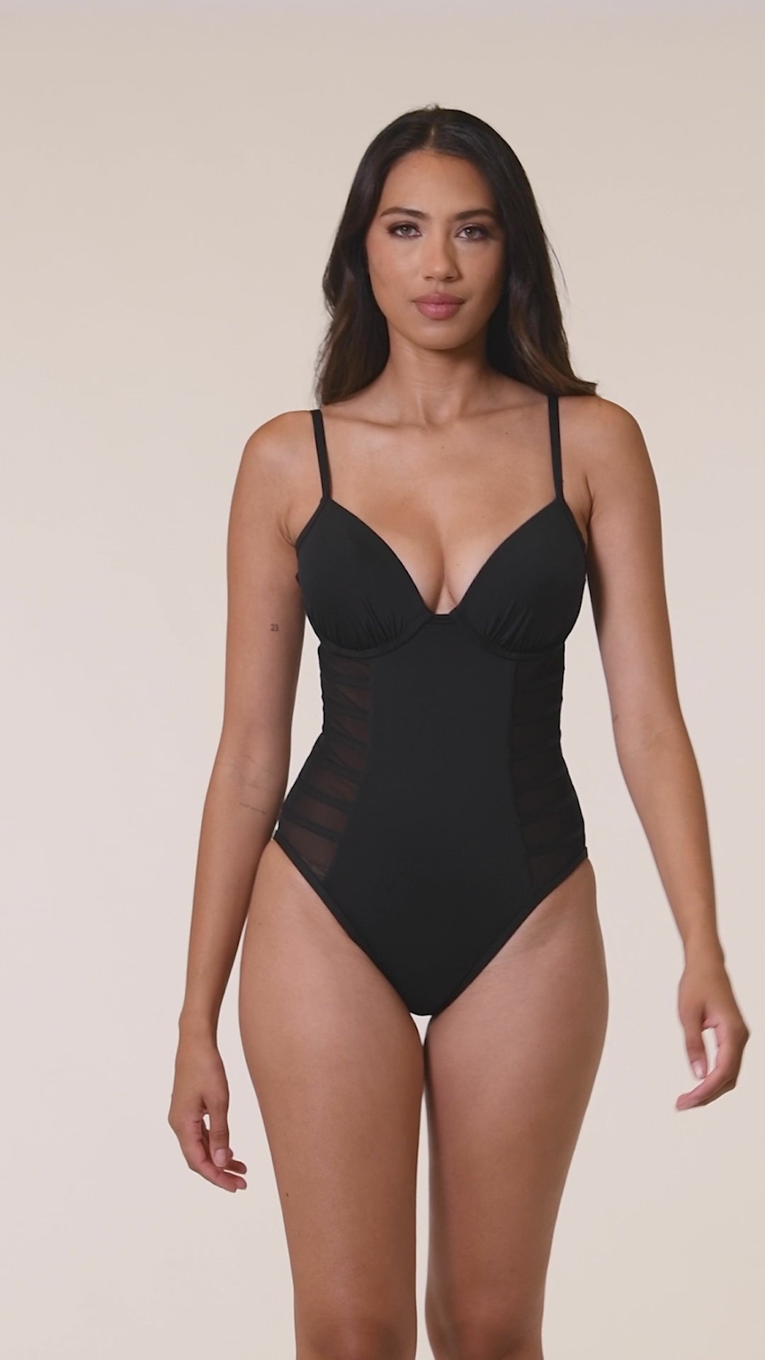 Model is wearing the Island Goddess Underwire Mesh One Piece in Black.