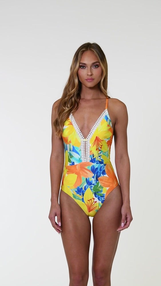 
                  
                    Load and play video in Gallery viewer, Model is wearing a blue, green, and orange multi colored floral printed plunge one piece swimsuit.
                  
                