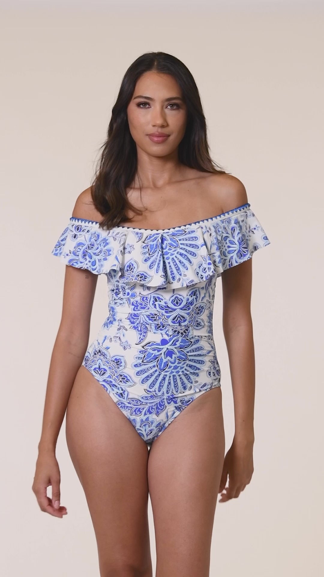 Model is wearing an indigo and white multicolored floral printed Off Shoulder Ruffle One Piece