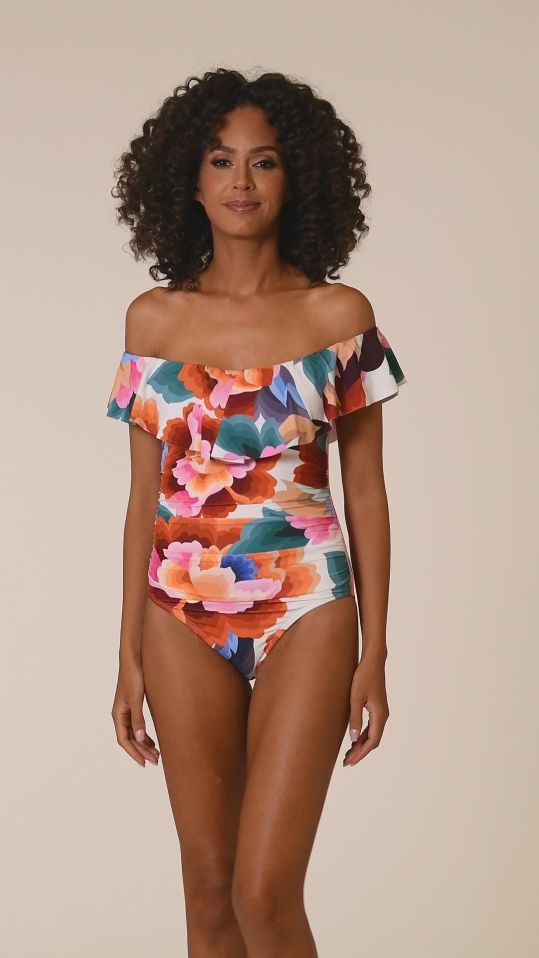 This is a video of a Model is wearing a multi colored floral printed off shoulder ruffle one piece from our Floral Rhythm collection!