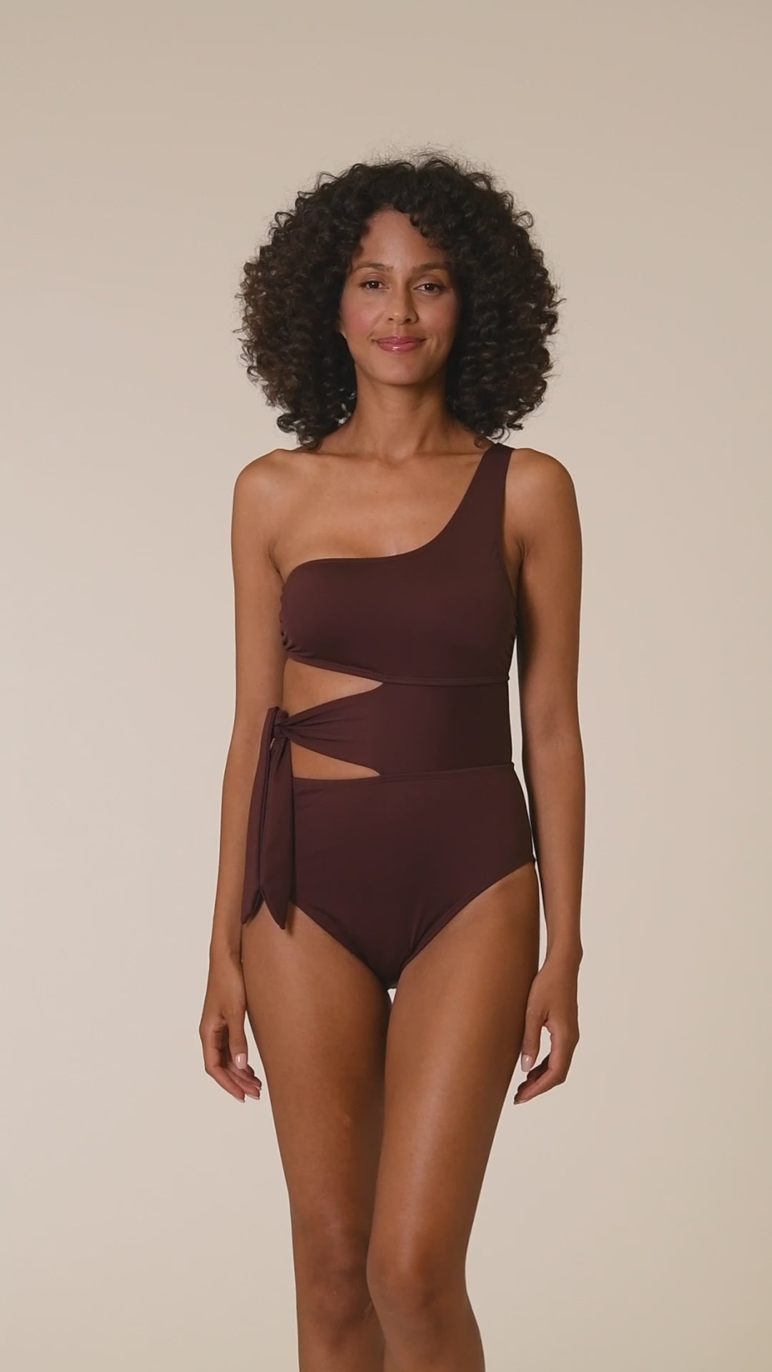 This is a video of a Model is wearing a java colored one piece swimsuit from our Best-Selling Island Goddess collection.