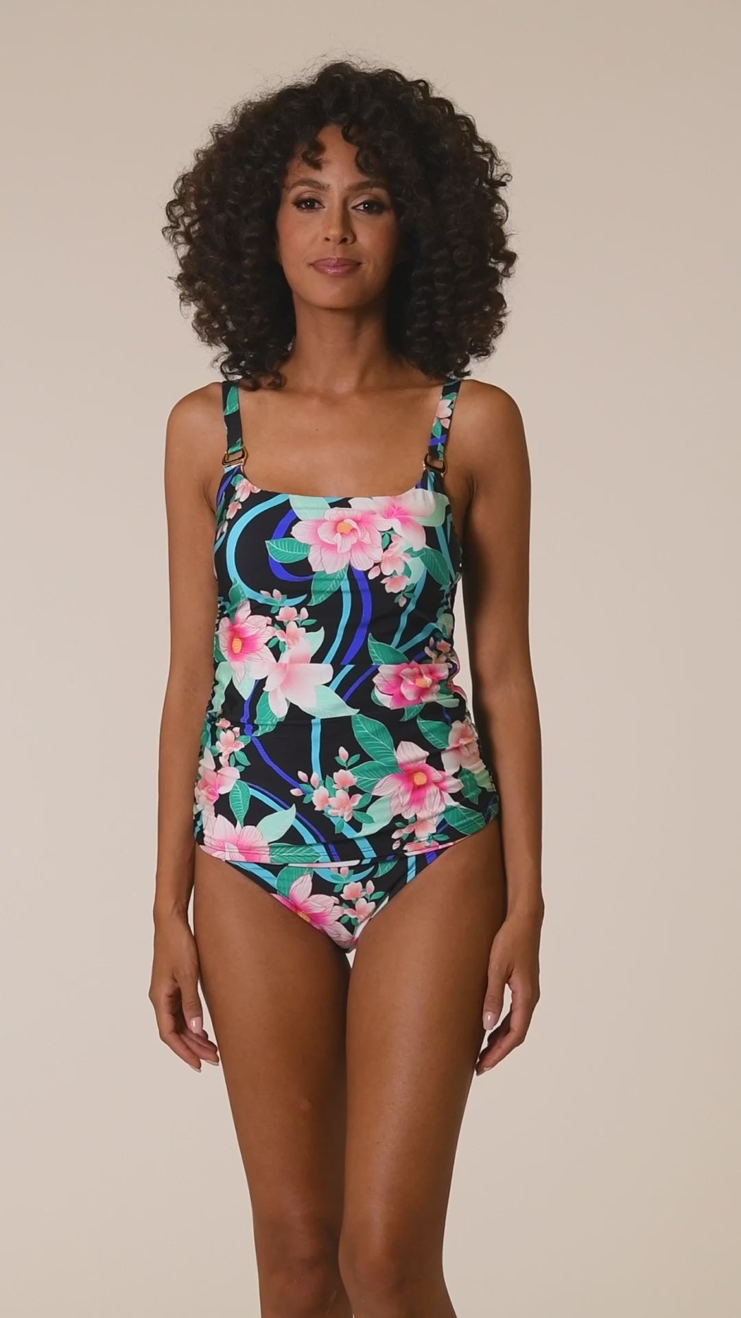 This is a video of a Model is wearing pink multi colored tropical foral print on this lingerie strap one piece from our Nightfall Blooms collection!