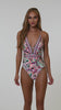 This is a video of a Model is wearing a pink multicolored paisley printed plunge one piece from our Sunshine 79 brand.