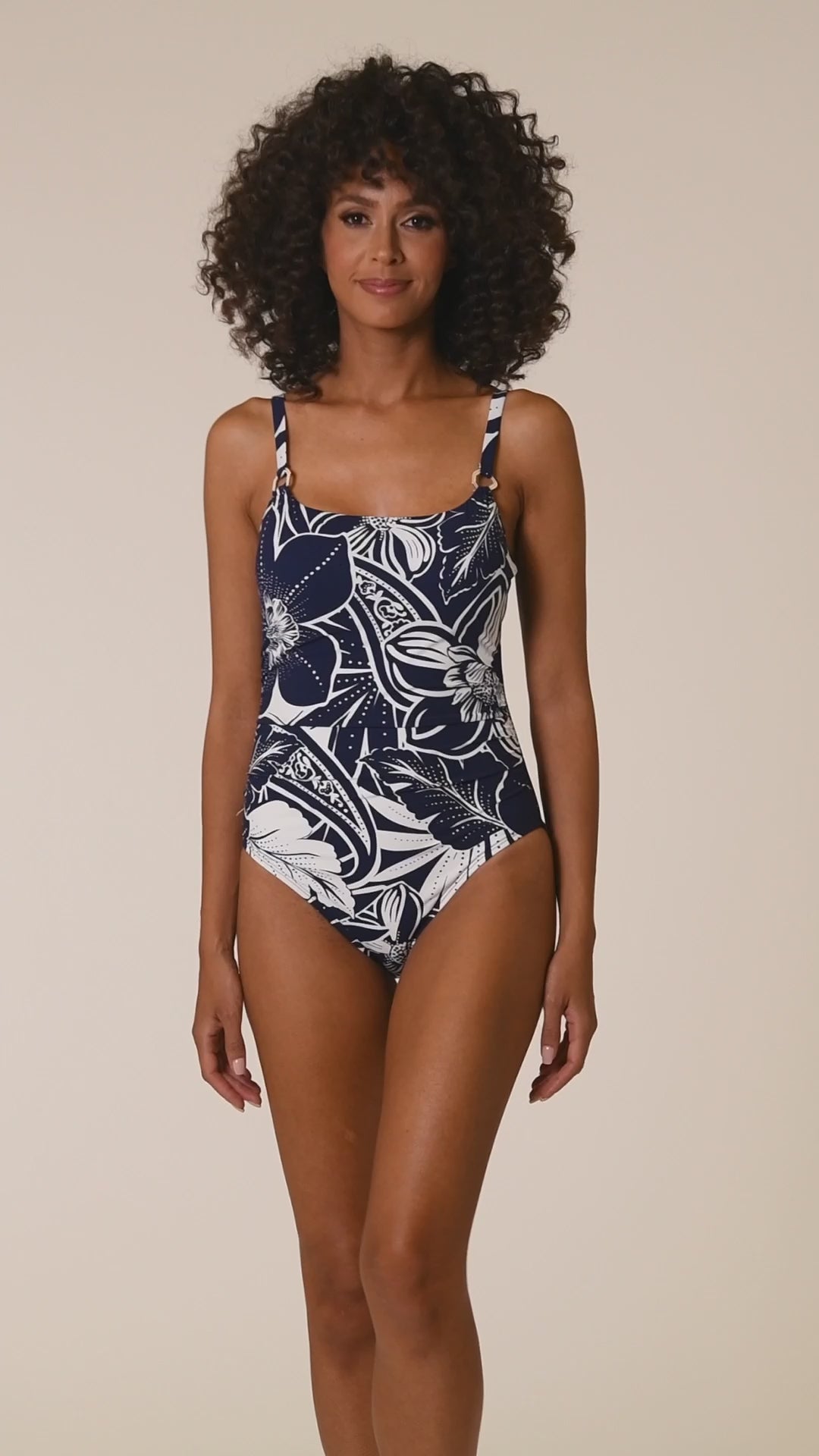 This is a video of a Model is wearing an indigo colored print with pops of white on this lingerie one piece from our At the Playa collection!