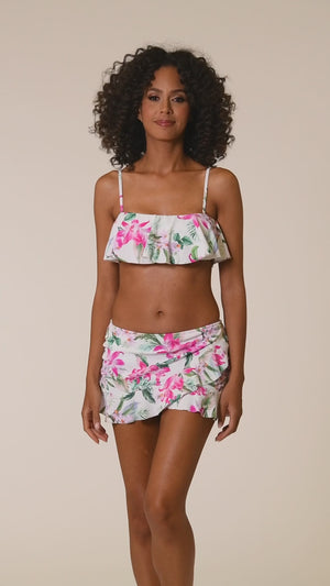 
            
                Load and play video in Gallery viewer, This is a video of a Model is wearing multi colored tropical print on a white backround with this asymmetrical ruffle skirted bottom from our Mystic Palms collection!
            
        