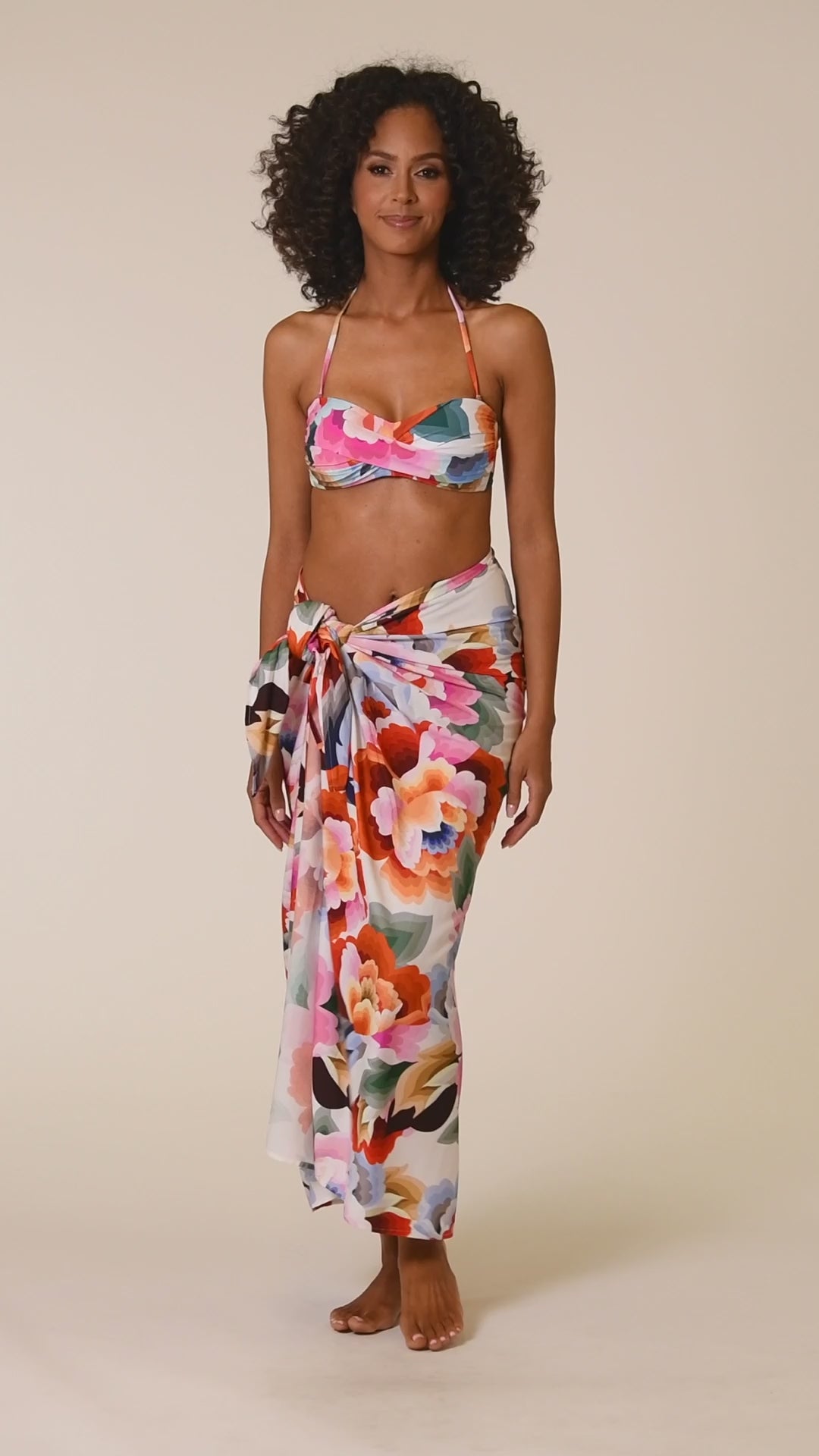 This is a video of a Model is wearing a multi colored floral printed bandeau top from our Floral Rhythm collection!