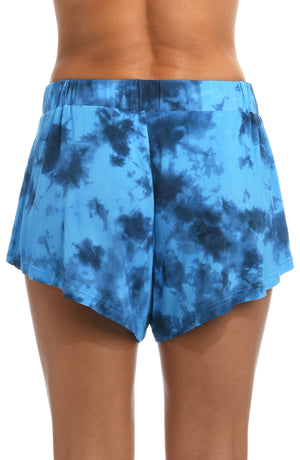 Model is wearing a blue dreamy cloud-inspired printed flounce short from our Head in the Clouds collection.