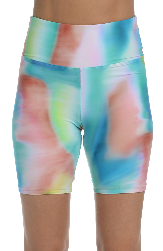 Model is wearing a multi-colored tie-dye inspired high waist bike short from our Sunset Tide collection!