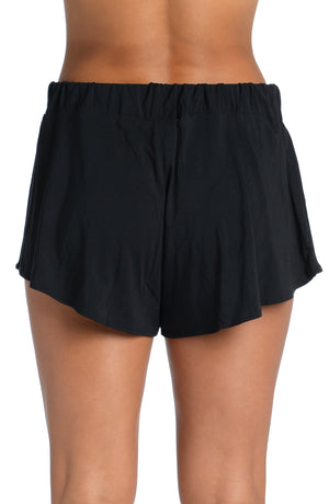
            
                Load image into Gallery viewer, Model is wearing a black colored flounce short from our Lounge Around Jersey collection.
            
        