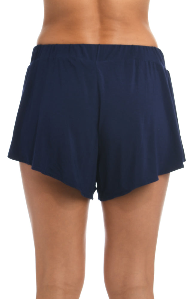 
            
                Load image into Gallery viewer, Model is wearing a midnight colored flounce shorts from our Lounge Around Jersey collection.
            
        