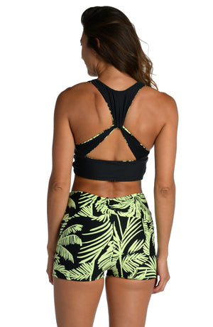 Model is wearing a green and black colored tropical printed mid waist bike short from our Abstract Palm collection!