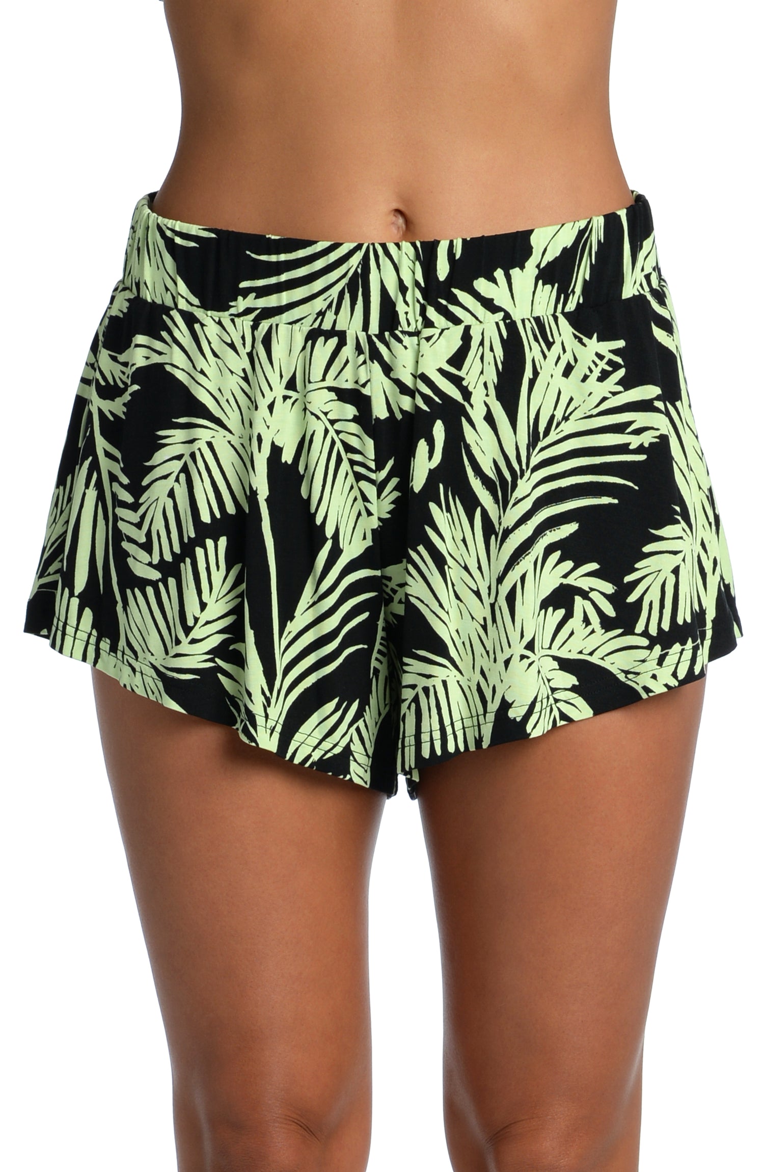 Model is wearing a green and black colored tropical printed flounce short from our Abstract Palm collection!