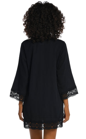 Model is wearing a black v-neck tunic swimsuit cover up from our Island Fare collection.