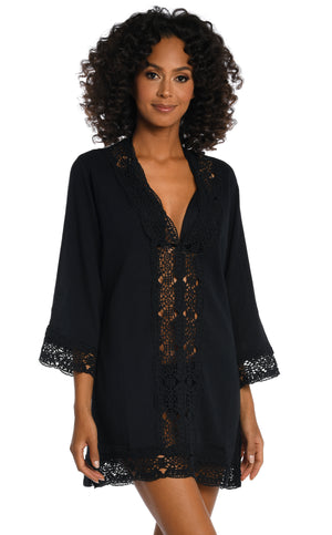 Model is wearing a black v-neck tunic swimsuit cover up from our Island Fare collection.