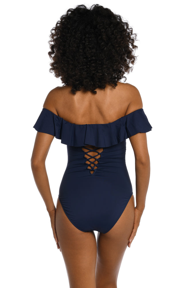 Model is wearing a indigo colored one piece swimsuit from our Best-Selling Island Goddess collection.
