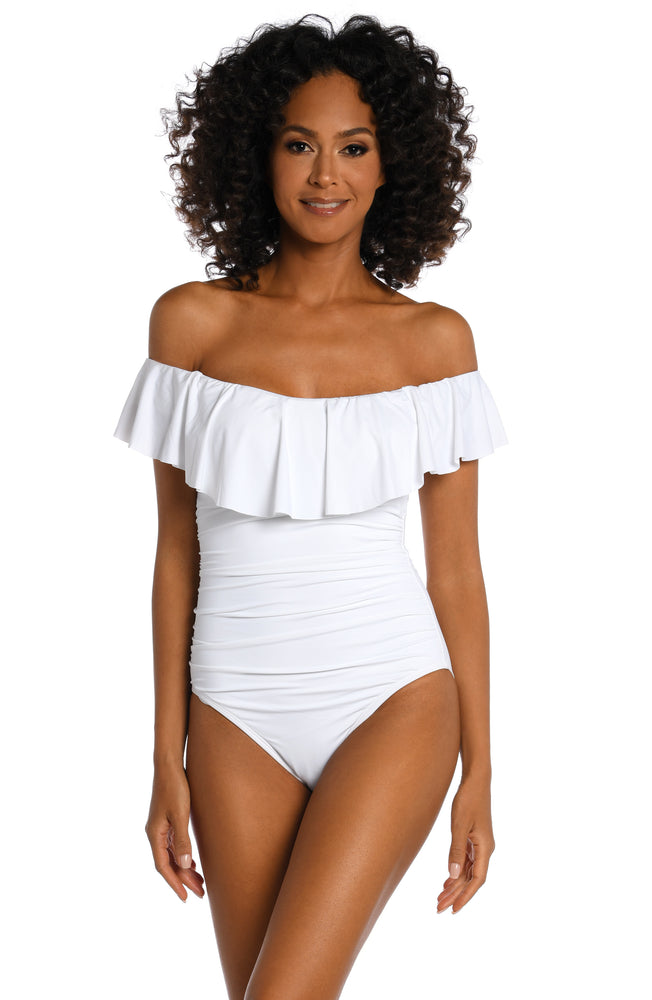 
            
                Load image into Gallery viewer, Model is wearing a white ruffle one piece swimsuit from our Best-Selling Island Goddess collection.
            
        