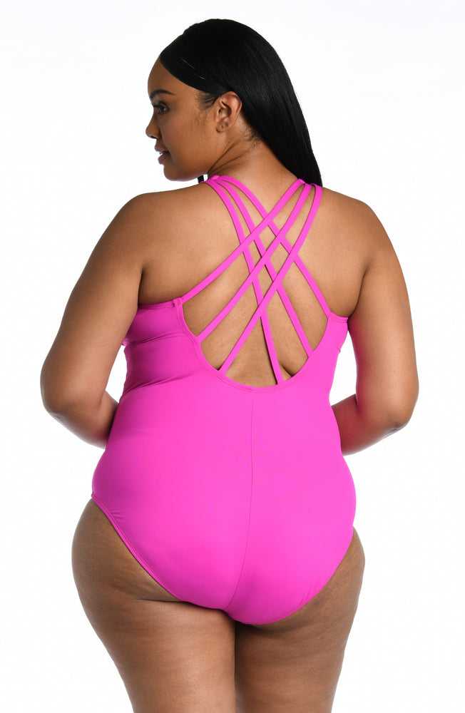 
            
                Load image into Gallery viewer, Model is wearing a orchid colored one piece swimsuit from our Best-Selling Island Goddess collection.
            
        