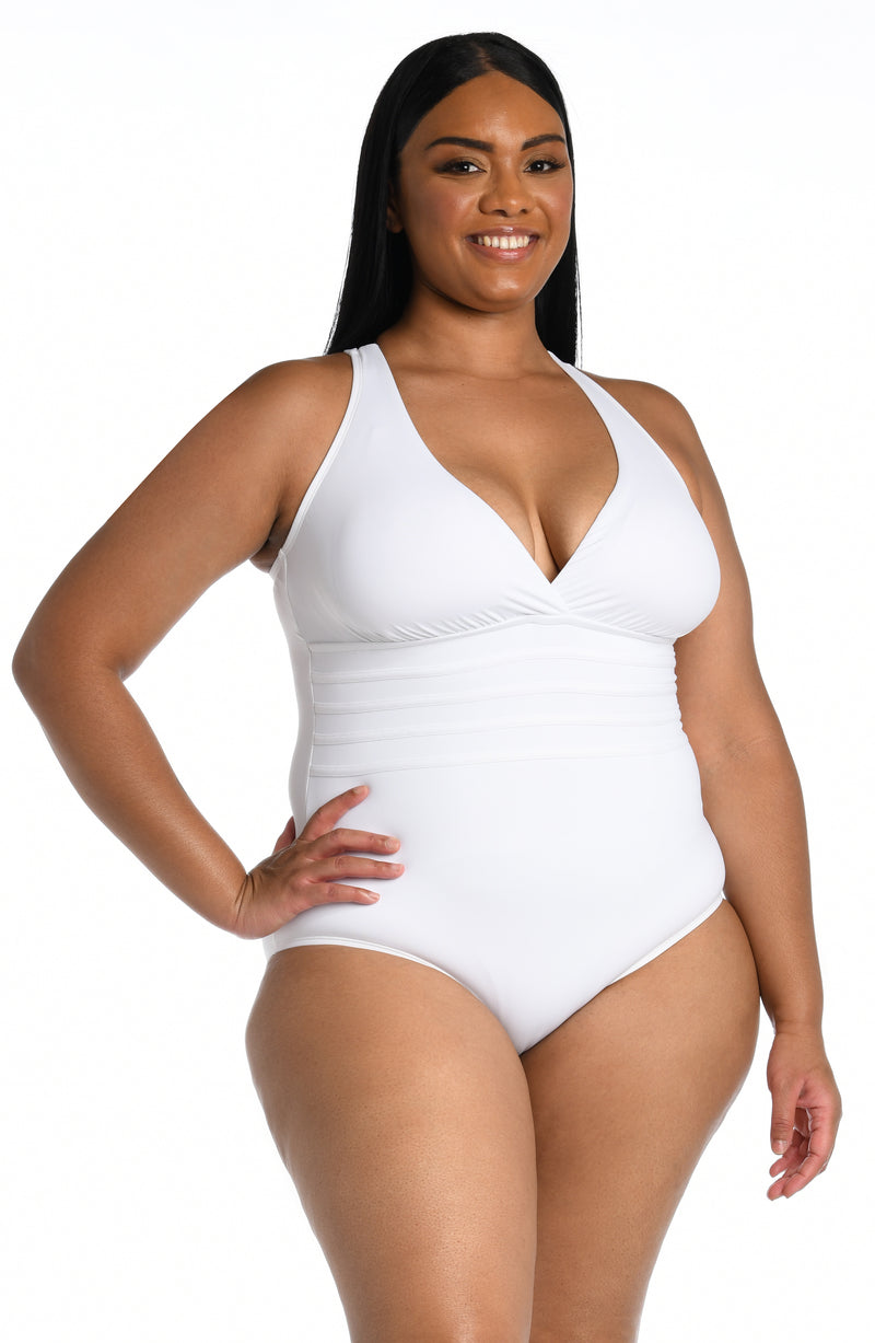 Model is wearing a white one piece swimsuit from our Best-Selling Island Goddess collection.